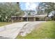 Front view of a ranch house with a carport at 139 Floridana Rd, Debary, FL 32713