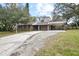House exterior with a long driveway and carport at 139 Floridana Rd, Debary, FL 32713