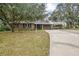 Ranch style home with carport and mature landscaping at 139 Floridana Rd, Debary, FL 32713