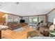 Open living area with hardwood floors and access to lanai at 139 Floridana Rd, Debary, FL 32713