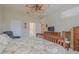 Spacious bedroom with a large bed, dresser, and ceiling fan at 1469 Carlow Cir, Ormond Beach, FL 32174