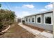 Side yard with walkway, shed, and mature landscaping at 15 Longfellow Cir, Ormond Beach, FL 32176