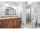 Clean bathroom with light blue walls, wood vanity, and glass shower at 15 Longfellow Cir, Ormond Beach, FL 32176