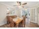 Bright dining room features a wooden table, four chairs, and access to a sunroom at 15 Longfellow Cir, Ormond Beach, FL 32176