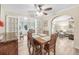 Cozy dining area with wood table and access to living room at 15 Longfellow Cir, Ormond Beach, FL 32176