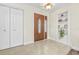 Bright and airy entryway with built-in shelving and tile floors at 15 Longfellow Cir, Ormond Beach, FL 32176