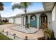 Charming home exterior with a landscaped walkway and palm tree at 15 Longfellow Cir, Ormond Beach, FL 32176