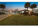 Inviting home exterior featuring a well-manicured lawn and palm trees at 15 Longfellow Cir, Ormond Beach, FL 32176