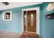 Inviting front door entry with teal walls and a decorative mailbox at 15 Longfellow Cir, Ormond Beach, FL 32176