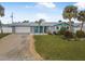 Ranch home with teal accents and palm trees at 15 Longfellow Cir, Ormond Beach, FL 32176