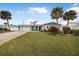 Ranch home with teal accents and palm trees at 15 Longfellow Cir, Ormond Beach, FL 32176