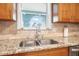 Modern kitchen sink with granite countertop and tile backsplash at 15 Longfellow Cir, Ormond Beach, FL 32176