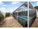Side view of a refreshing, screened-in pool area at 15 Longfellow Cir, Ormond Beach, FL 32176