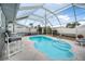 Relaxing screened pool with patio furniture in backyard at 15 Longfellow Cir, Ormond Beach, FL 32176
