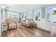 Bright sunroom features hardwood floors, comfy seating, and pool view at 15 Longfellow Cir, Ormond Beach, FL 32176