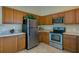 Stainless steel appliances and wood cabinets in kitchen at 1520 3Rd Ave, Deland, FL 32724