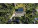 Aerial view of house, pool, and lush green surroundings at 163 Laurelwood Ln, Ormond Beach, FL 32174