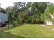 Spacious backyard with lush landscaping and a patio area at 163 Laurelwood Ln, Ormond Beach, FL 32174