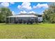 Large backyard with a screened pool and patio area at 163 Laurelwood Ln, Ormond Beach, FL 32174