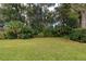 Landscaped backyard with tropical plants and trees at 163 Laurelwood Ln, Ormond Beach, FL 32174