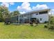 Home's backyard features a pool, patio, and screened enclosure at 163 Laurelwood Ln, Ormond Beach, FL 32174