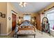 Cozy bedroom featuring a wooden bed frame and ample natural light at 163 Laurelwood Ln, Ormond Beach, FL 32174