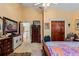 Bedroom with king-size bed, dresser, and access to upper hallway at 163 Laurelwood Ln, Ormond Beach, FL 32174
