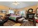Bright bedroom with a king-size bed and wood furniture at 163 Laurelwood Ln, Ormond Beach, FL 32174