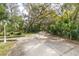 Long driveway leading to a home, surrounded by trees at 163 Laurelwood Ln, Ormond Beach, FL 32174