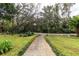 Landscaped front yard with a stone path leading to the home at 163 Laurelwood Ln, Ormond Beach, FL 32174