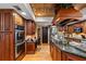 Kitchen features double ovens, granite counters, and wood cabinets at 163 Laurelwood Ln, Ormond Beach, FL 32174