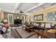 Spacious living room with leather sofas, stone wall, and large TV at 163 Laurelwood Ln, Ormond Beach, FL 32174
