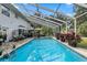 Inviting screened pool area with patio and lush landscaping at 163 Laurelwood Ln, Ormond Beach, FL 32174