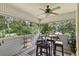 Relaxing screened porch with outdoor seating and lush greenery views at 163 Laurelwood Ln, Ormond Beach, FL 32174