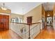 Elegant upstairs hallway with hardwood floors and a charming tapestry at 163 Laurelwood Ln, Ormond Beach, FL 32174