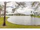 Community lake view with fountain and houses along the shoreline at 1734 Covendale Ln, Port Orange, FL 32128