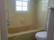 Bathroom with bathtub, toilet and tiled walls at 1848 Ridgewood St, Deland, FL 32720