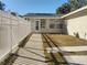 Side yard with a white picket fence and a walkway at 1848 Ridgewood St, Deland, FL 32720