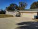 Front of the house with a large driveway and double car garage at 1848 Ridgewood St, Deland, FL 32720