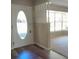 Front door entry with an oval window and laminate flooring at 1848 Ridgewood St, Deland, FL 32720