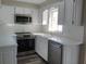 Updated kitchen featuring white cabinets and stainless steel appliances at 1848 Ridgewood St, Deland, FL 32720