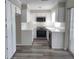 Modern kitchen with white cabinets, stainless steel appliances and vinyl flooring at 1848 Ridgewood St, Deland, FL 32720