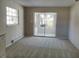Bright living room with sliding glass doors leading to a sunroom at 1848 Ridgewood St, Deland, FL 32720