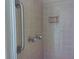 Clean shower with grab bar and tiled walls at 1848 Ridgewood St, Deland, FL 32720