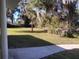 Landscaped side yard with mature trees and grass at 1848 Ridgewood St, Deland, FL 32720