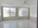 Bright sunroom with tile flooring, ceiling fan and window blinds at 1848 Ridgewood St, Deland, FL 32720