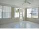 Bright sunroom with tile flooring, ceiling fan, and multiple windows at 1848 Ridgewood St, Deland, FL 32720