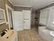 Updated bathroom with shower, bathtub, and modern vanity at 1937 N Spring Garden Ave, Deland, FL 32720