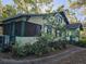 House with a large yard and mature trees surrounding it at 1937 N Spring Garden Ave, Deland, FL 32720