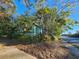 Light-green house with teal accents, nestled among lush trees at 1937 N Spring Garden Ave, Deland, FL 32720